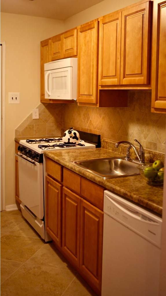 Kitchen with brown cabinetry at Joshua House apartments for rent in Philadelphia, PA